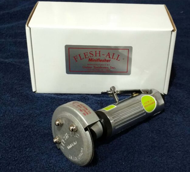 The Flesh All Mini Flesher and Box kept on a blue background